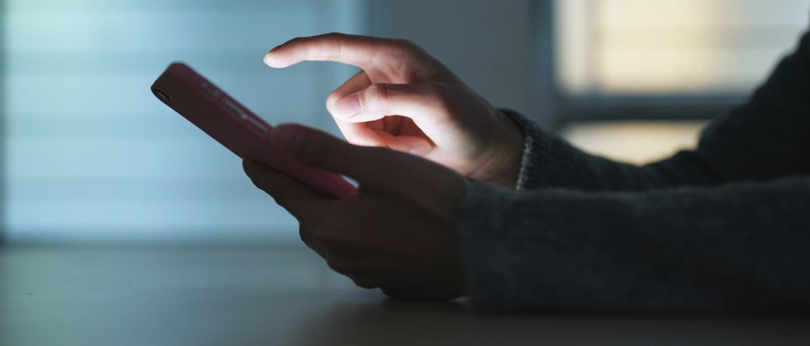 Woman sending sms on mobile phone